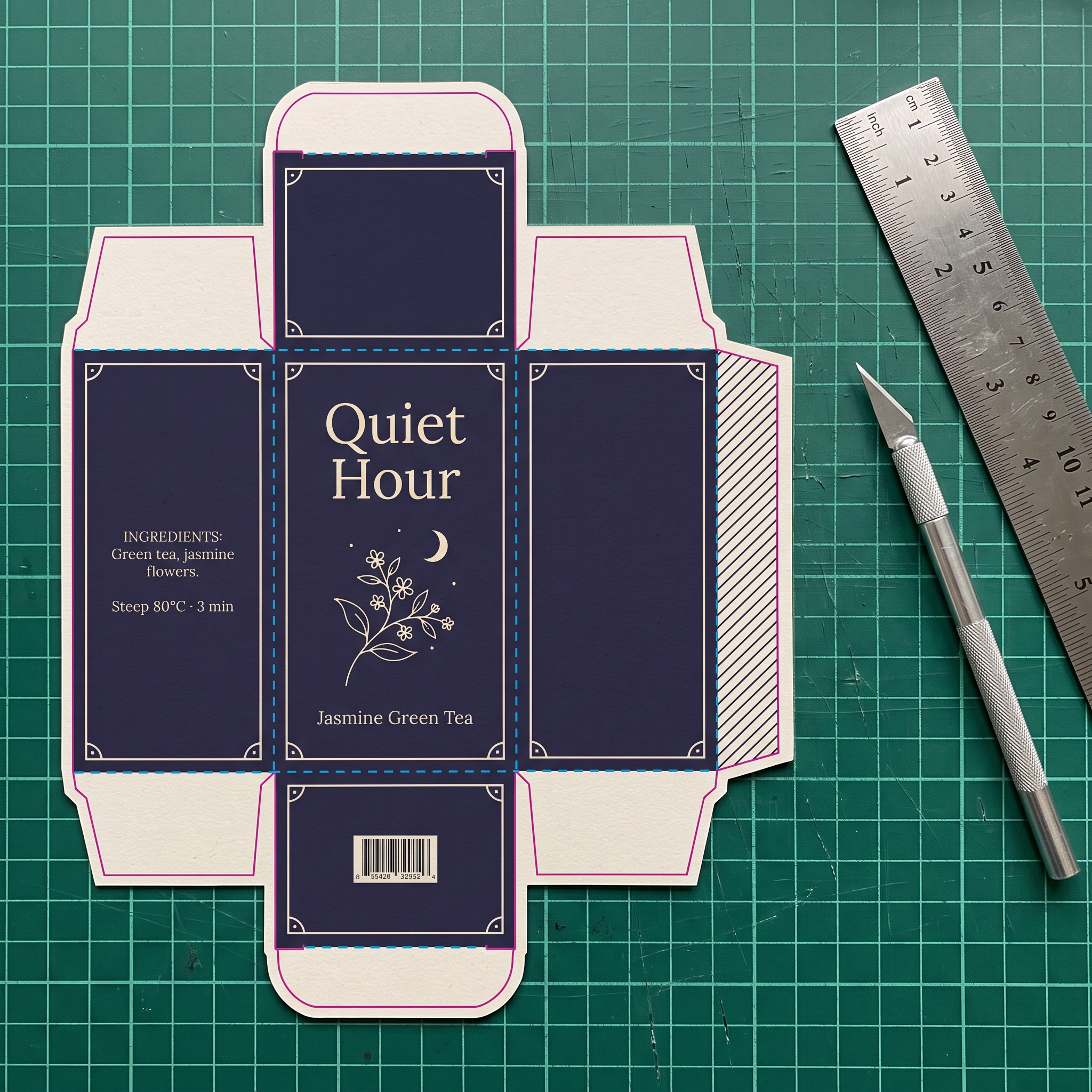 An unfolded tea box dieline on a cutting mat with cut and fold lines and printed artwork
